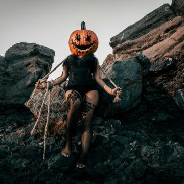 image of a woman in black lingerie with a jackolantern on her head