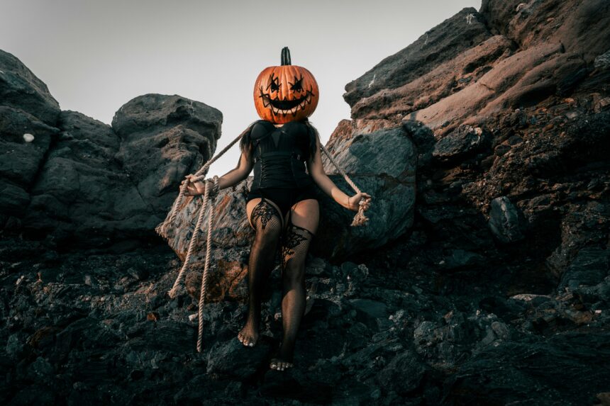 image of a woman in black lingerie with a jackolantern on her head